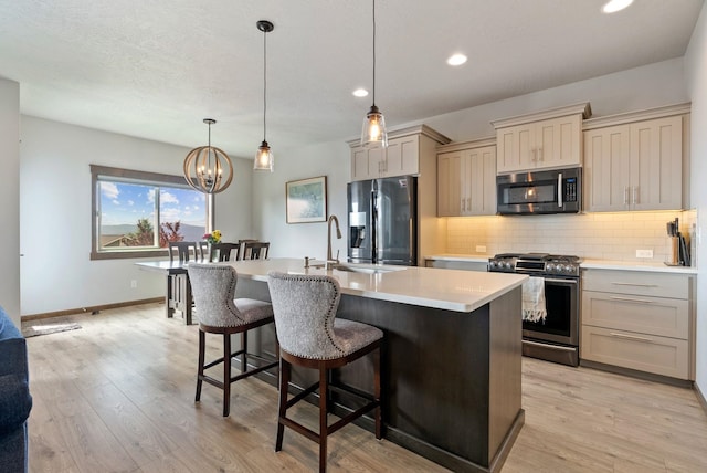 8814 E Clearview Ln, Spokane, WA 99217 - kitchen with stainless steel appliances, tasteful backsplash, recessed lighting, light countertops, and a breakfast bar
