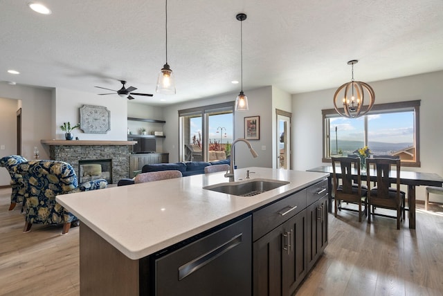 8814 E Clearview Ln, Spokane, WA 99217 - kitchen with dishwasher, light countertops, light wood-type flooring, hanging light fixtures, and recessed lighting