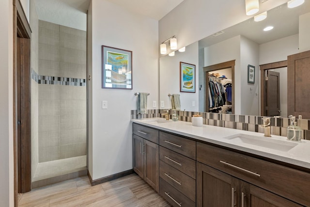 8814 E Clearview Ln, Spokane, WA 99217 - full bathroom featuring double vanity, a walk in closet, wood finished floors, and walk in shower