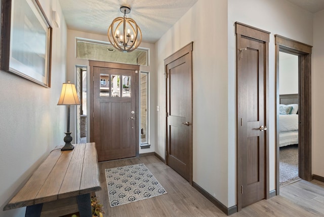 8814 E Clearview Ln, Spokane, WA 99217 - entryway featuring a chandelier and light wood-style flooring