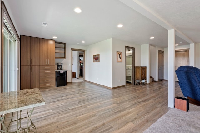 8814 E Clearview Ln, Spokane, WA 99217 - kitchen with open floor plan, open shelves, recessed lighting, light wood finished floors, and brown cabinets