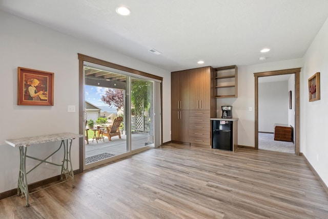 8814 E Clearview Ln, Spokane, WA 99217 - interior space featuring light wood finished floors, open shelves, recessed lighting, light countertops, and freestanding refrigerator