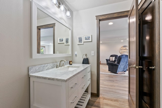 8814 E Clearview Ln, Spokane, WA 99217 - bathroom with vanity, wood finished floors, and recessed lighting