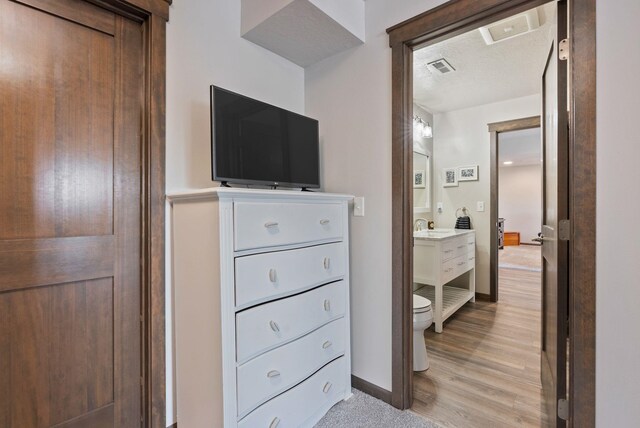 8814 E Clearview Ln, Spokane, WA 99217 - bedroom with light wood finished floors and a sink