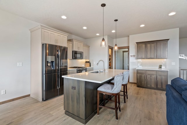 8814 E Clearview Ln, Spokane, WA 99217 - kitchen with fridge with ice dispenser, backsplash, light wood-type flooring, and recessed lighting