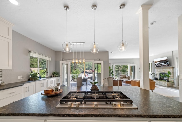 4171 S Westway Dr, Coeur D Alene, ID 83814 - kitchen featuring stainless steel gas stovetop, plenty of natural light, white cabinetry, and decorative light fixtures