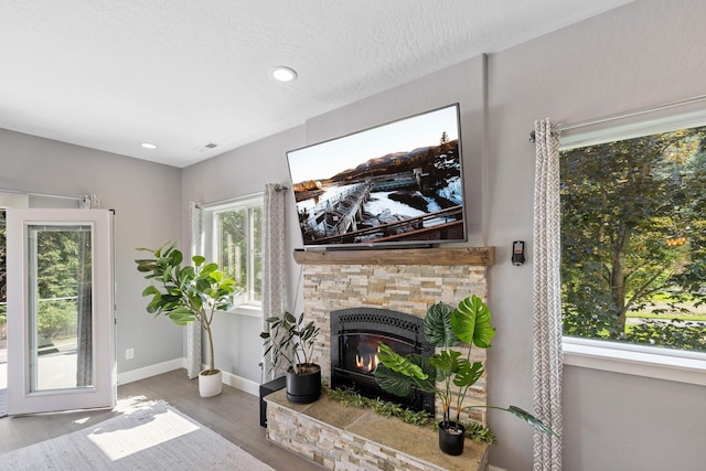 4171 S Westway Dr, Coeur D Alene, ID 83814 - living area featuring wood finished floors, a stone fireplace, and recessed lighting