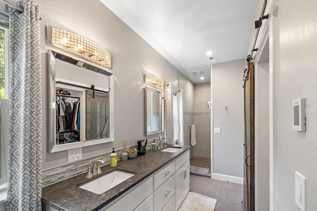 4171 S Westway Dr, Coeur D Alene, ID 83814 - full bathroom with double vanity, tile patterned floors, a shower stall, and a walk in closet