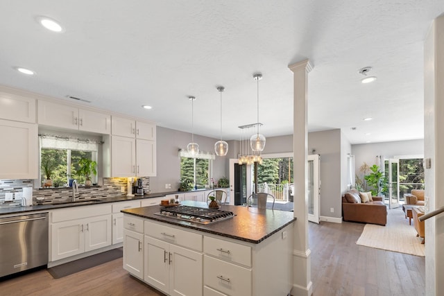 4171 S Westway Dr, Coeur D Alene, ID 83814 - kitchen with stainless steel appliances, decorative backsplash, healthy amount of natural light, wood finished floors, and recessed lighting