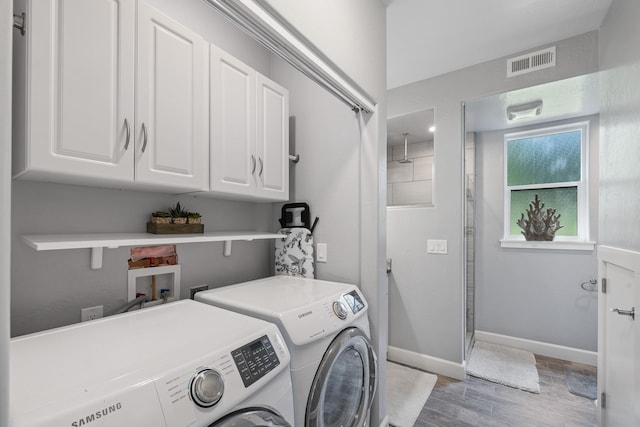 4171 S Westway Dr, Coeur D Alene, ID 83814 - washroom featuring cabinet space, washer and clothes dryer, and light wood-style flooring