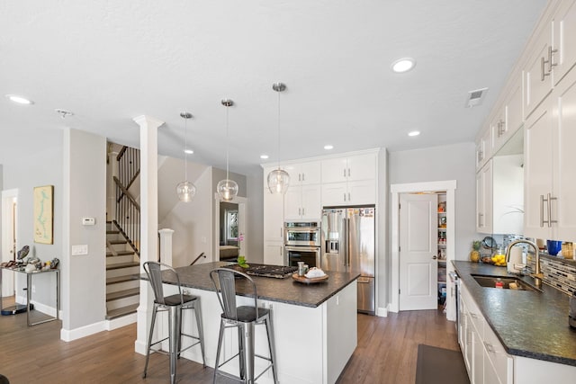 4171 S Westway Dr, Coeur D Alene, ID 83814 - kitchen with stainless steel appliances, dark countertops, dark wood finished floors, a center island, and recessed lighting