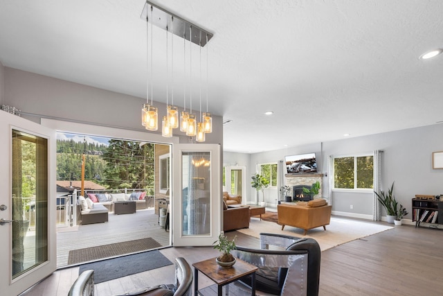 4171 S Westway Dr, Coeur D Alene, ID 83814 - dining room featuring a stone fireplace, wood finished floors, recessed lighting, and a chandelier