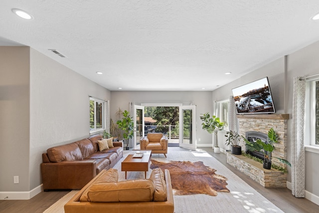 4171 S Westway Dr, Coeur D Alene, ID 83814 - living area featuring a fireplace with raised hearth, light wood-style floors, a textured ceiling, and recessed lighting