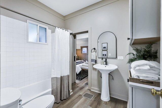 613 W Kiernan Ave, Spokane, WA 99205 - bathroom with wood finished floors and shower / bathtub combination with curtain