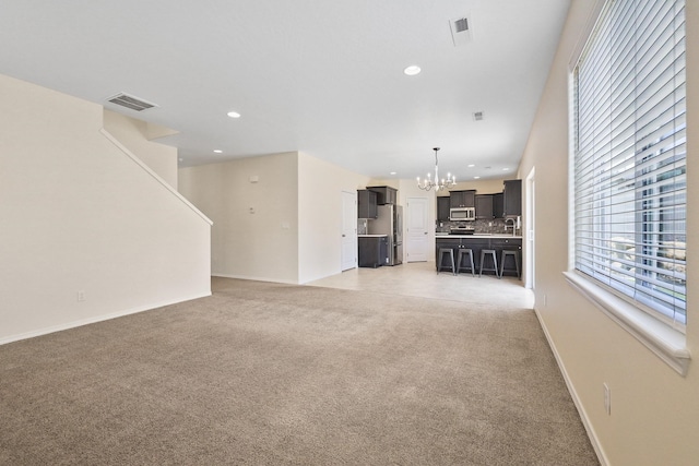 4813 S Lapwai Ln, Spokane, WA 99206 - unfurnished living room featuring a chandelier, recessed lighting, and light colored carpet