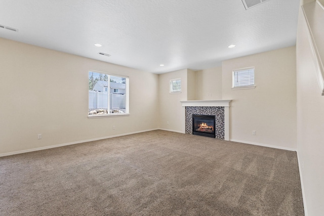 4813 S Lapwai Ln, Spokane, WA 99206 - unfurnished living room with carpet, a tiled fireplace, and recessed lighting