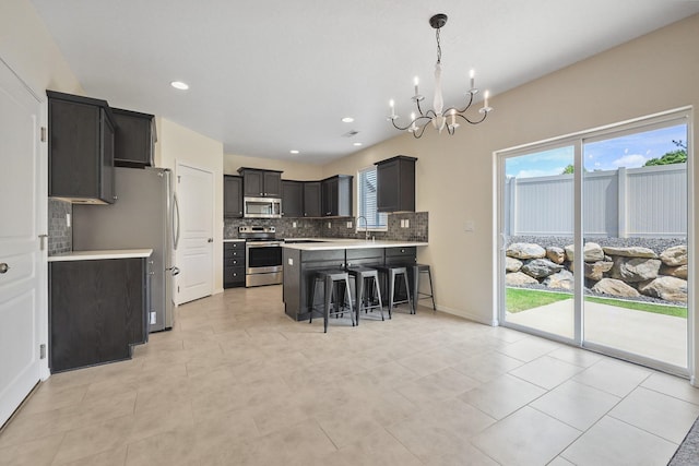 4813 S Lapwai Ln, Spokane, WA 99206 - kitchen featuring stainless steel appliances, a chandelier, tasteful backsplash, light countertops, and a breakfast bar