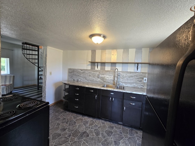 1528 E Boone Ave, Spokane, WA 99202 - kitchen featuring black appliances, open shelves, a textured ceiling, and dark cabinetry