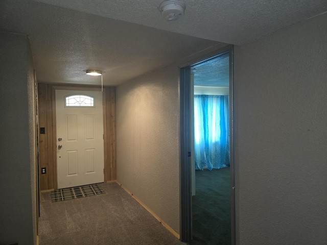 1528 E Boone Ave, Spokane, WA 99202 - doorway with a textured wall, carpet flooring, a textured ceiling, and healthy amount of natural light
