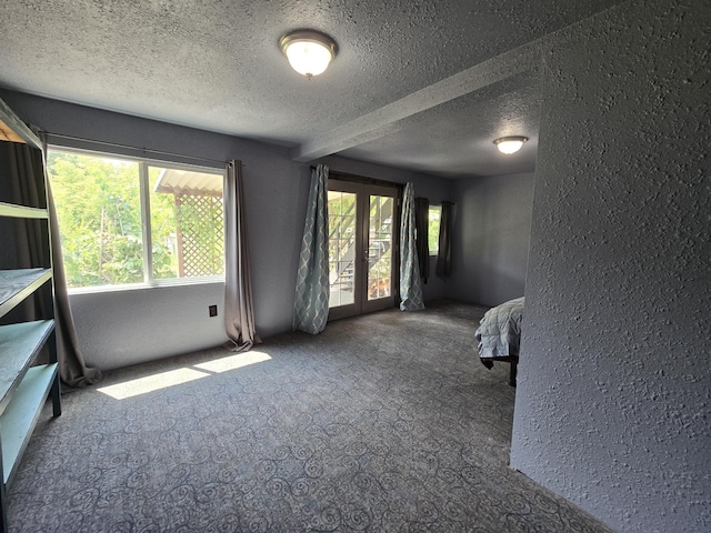 1528 E Boone Ave, Spokane, WA 99202 - carpeted empty room featuring french doors, a textured ceiling, and a textured wall
