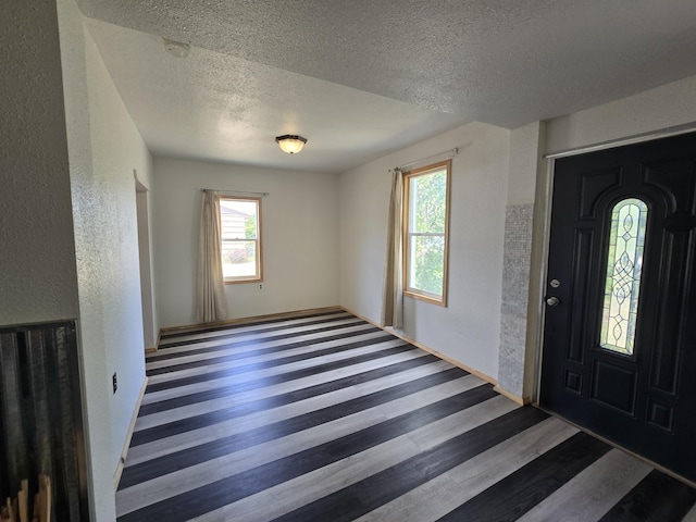 1528 E Boone Ave, Spokane, WA 99202 - foyer entrance with a textured ceiling, a textured wall, and wood finished floors