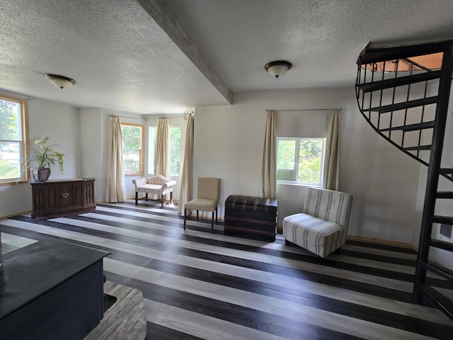 1528 E Boone Ave, Spokane, WA 99202 - sitting room featuring a textured ceiling, plenty of natural light, wood finished floors, and stairs