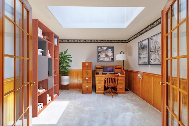 10207 N Comanche Dr, Spokane, WA 99208 - carpeted home office featuring french doors, wainscoting, wood walls, and a skylight