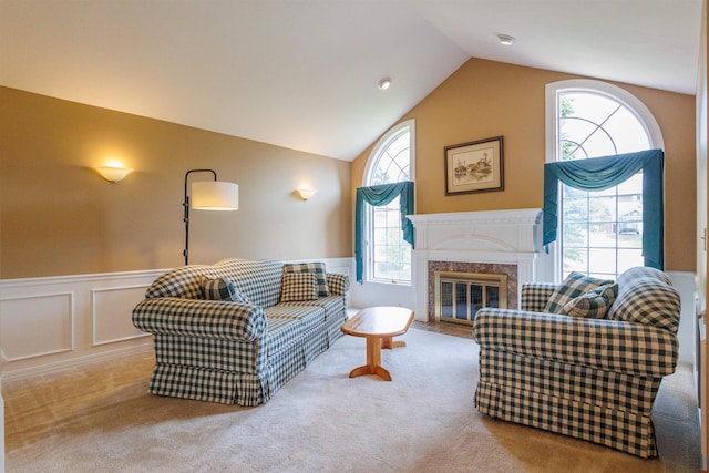 10207 N Comanche Dr, Spokane, WA 99208 - carpeted living room with wainscoting, a fireplace, a decorative wall, and high vaulted ceiling