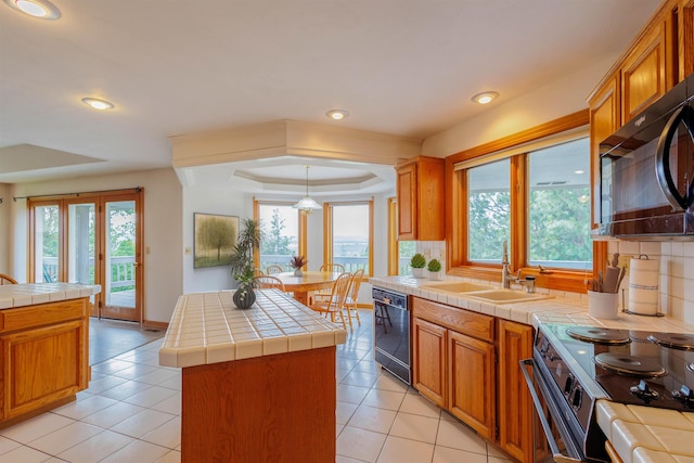 10207 N Comanche Dr, Spokane, WA 99208 - kitchen featuring black appliances, tile countertops, a kitchen island, decorative backsplash, and recessed lighting