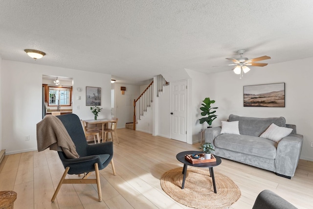 7878 N Wilding Dr # 32, Spokane, WA 99208 - living room with a textured ceiling, stairway, light wood finished floors, and ceiling fan
