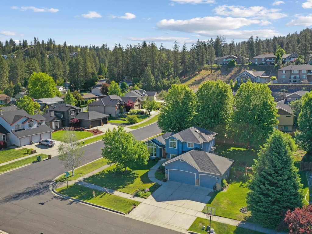 9410 N Seminole Dr, Spokane, WA 99208 - aerial perspective of suburban area with a heavily wooded area