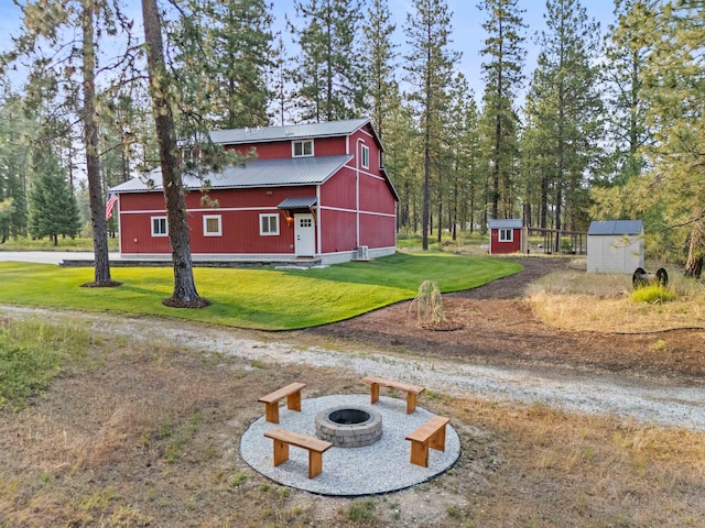 3 W Montgomery Rd, Deer Park, WA 99006 - view of side of property featuring a lawn, a metal roof, a fire pit, a shed, and a barn