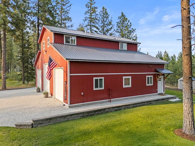 3 W Montgomery Rd, Deer Park, WA 99006 - view of side of home featuring a metal roof, a garage, a lawn, and driveway