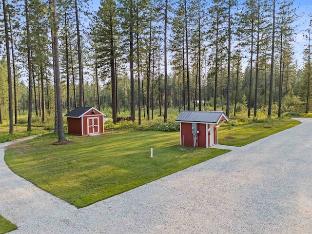3 W Montgomery Rd, Deer Park, WA 99006 - view of grassy yard featuring a storage unit, driveway, and a detached garage