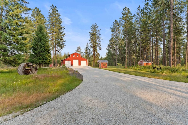 3 W Montgomery Rd, Deer Park, WA 99006 - view of front of house with a garage, an outdoor structure, gravel driveway, and a barn