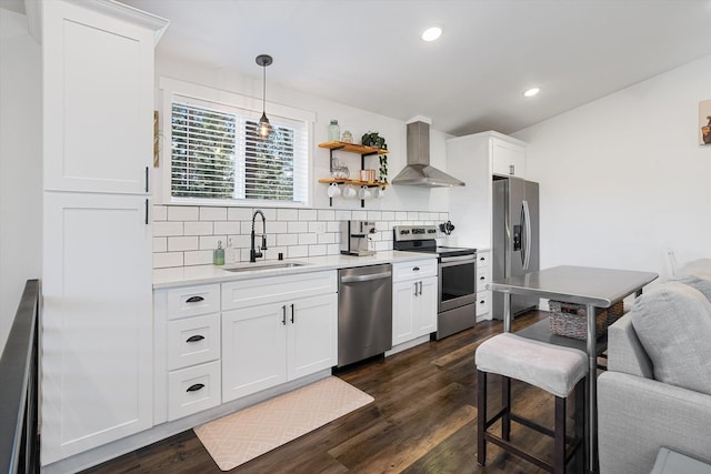 3 W Montgomery Rd, Deer Park, WA 99006 - kitchen with stainless steel appliances, wall chimney exhaust hood, decorative backsplash, dark wood-type flooring, and light countertops