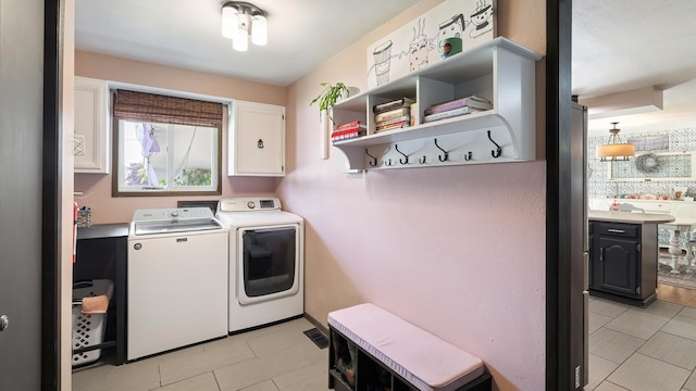 709 W Clay Ave, Chewelah, WA 99109 - laundry room with washing machine and clothes dryer, cabinet space, and light tile patterned flooring