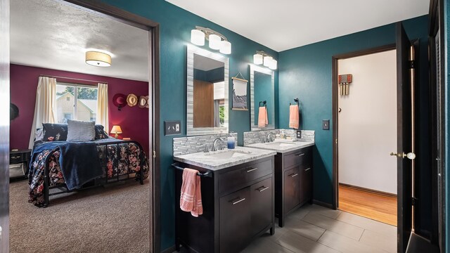 709 W Clay Ave, Chewelah, WA 99109 - bathroom with connected bathroom, backsplash, and vanity