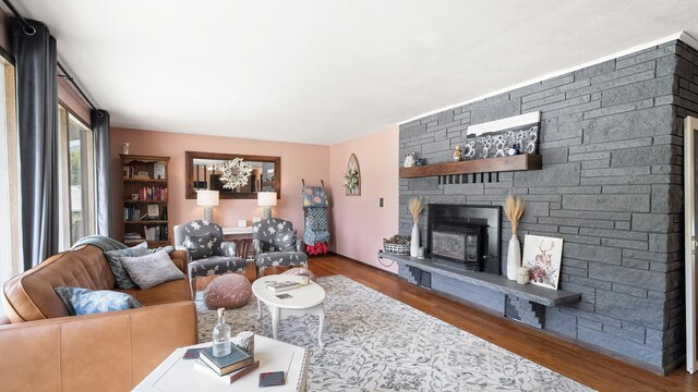 709 W Clay Ave, Chewelah, WA 99109 - living room featuring a stone fireplace and wood finished floors