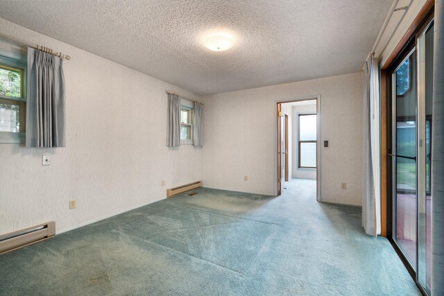 4112 S Hogan St, Spokane, WA 99203 - spare room featuring baseboard heating, a textured ceiling, carpet, and plenty of natural light