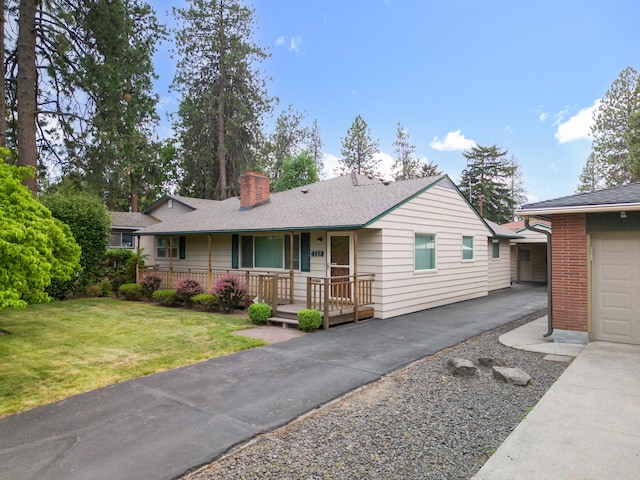 4112 S Hogan St, Spokane, WA 99203 - ranch-style home with a porch, a chimney, a front lawn, a shingled roof, and brick siding