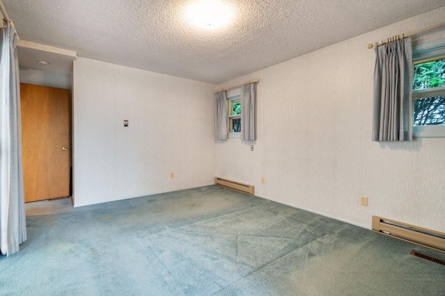 4112 S Hogan St, Spokane, WA 99203 - carpeted empty room featuring a baseboard radiator and a textured ceiling