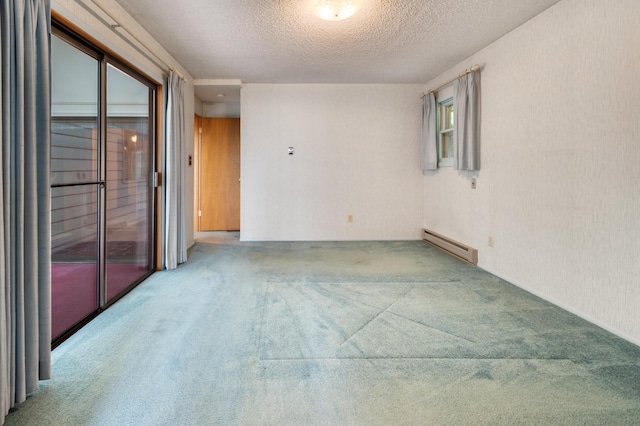 4112 S Hogan St, Spokane, WA 99203 - carpeted empty room featuring a baseboard heating unit and a textured ceiling