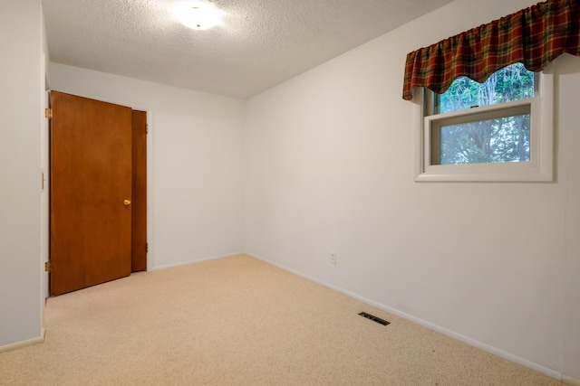 4112 S Hogan St, Spokane, WA 99203 - carpeted spare room featuring a textured ceiling and baseboards
