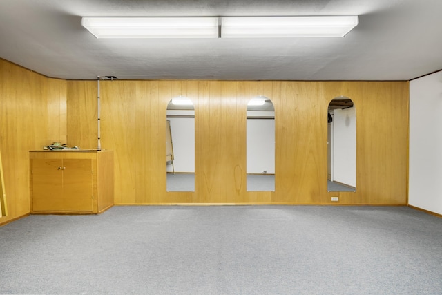 4112 S Hogan St, Spokane, WA 99203 - unfurnished room featuring carpet flooring, wood walls, and arched walkways