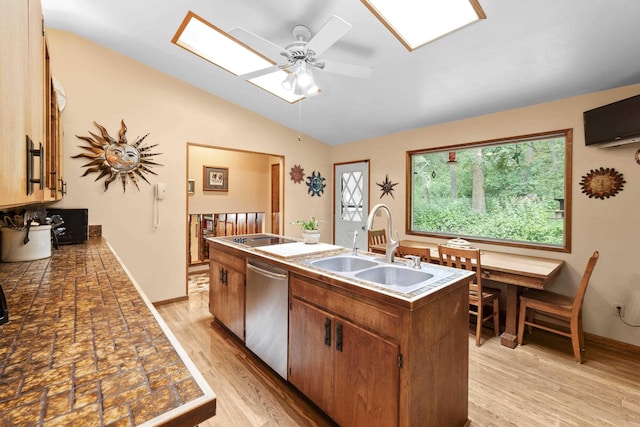 13614 N Minihdoka Trl, Spokane, WA 99208 - kitchen featuring dishwasher, a skylight, vaulted ceiling, a ceiling fan, and an island with sink