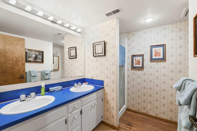 13614 N Minihdoka Trl, Spokane, WA 99208 - full bathroom with wood finished floors, wallpapered walls, double vanity, and a stall shower