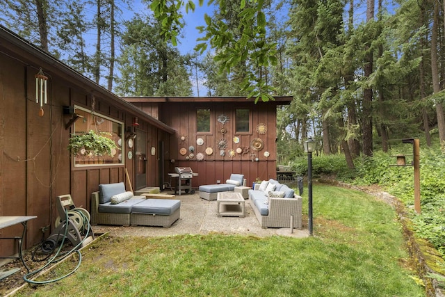 13614 N Minihdoka Trl, Spokane, WA 99208 - rear view of house featuring an outdoor living space, board and batten siding, a lawn, and a patio area