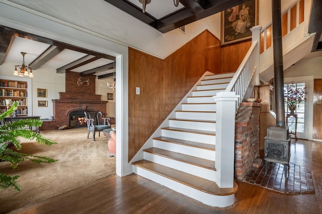1625 S Hayford Rd, Spokane, WA 99224 - stairway with beam ceiling, hardwood / wood-style floors, a wood stove, wood walls, and a fireplace