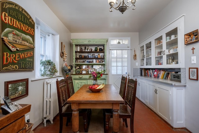 1625 S Hayford Rd, Spokane, WA 99224 - dining area with radiator, a chandelier, and dark tile patterned flooring
